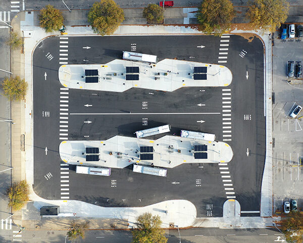 An aerial drone view of the Downtown Transfer Station with buses entering and leaving the space.