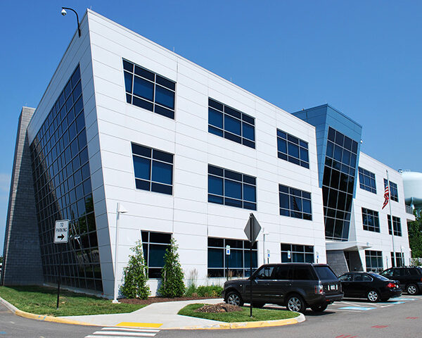 The GRTC headquarters building against a blue cloudless sky Two Accessible spots in the front.