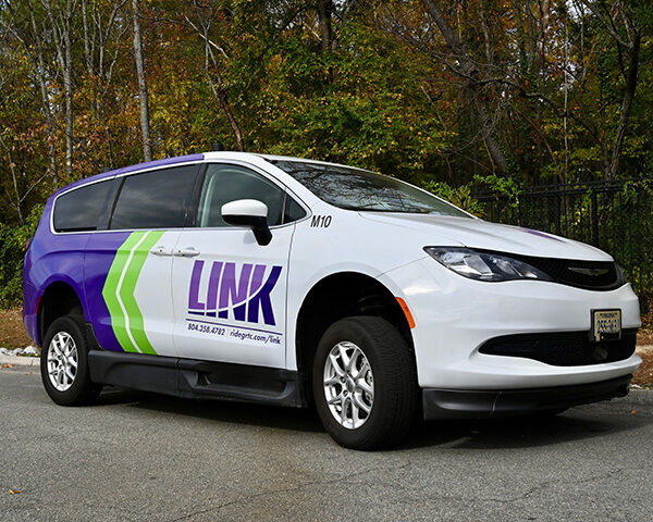 A link Van waits in a parking lot