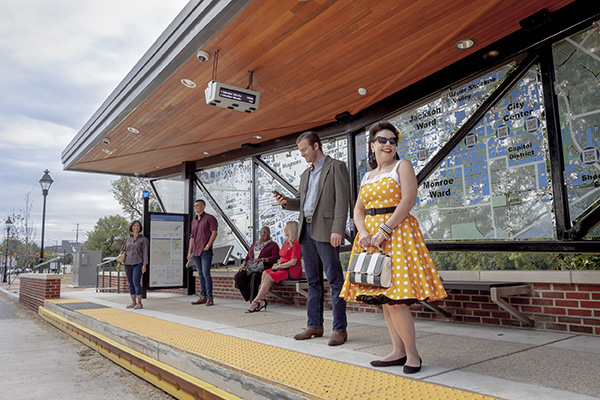 Riders wait for the bus at a pulse station.