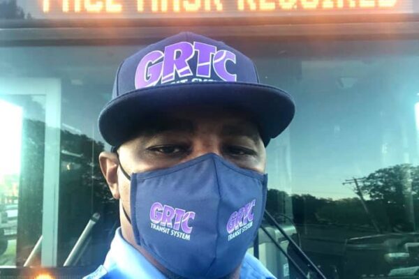 Face mask required on bus marque as message with masked bus driver in front