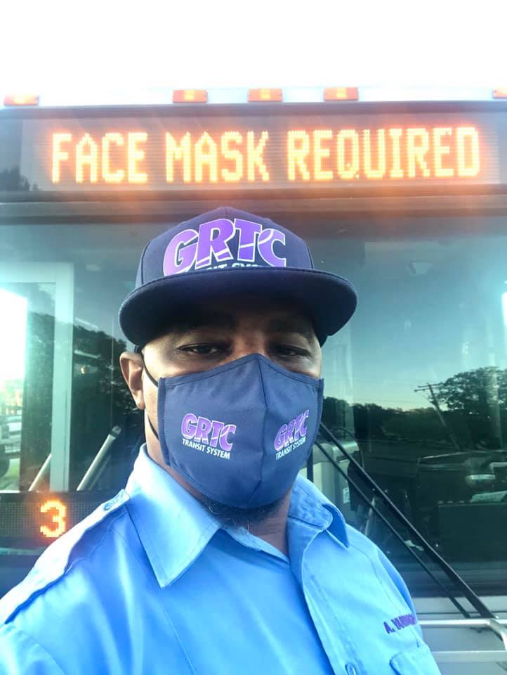 Face mask required on bus marque as message with masked bus driver in front