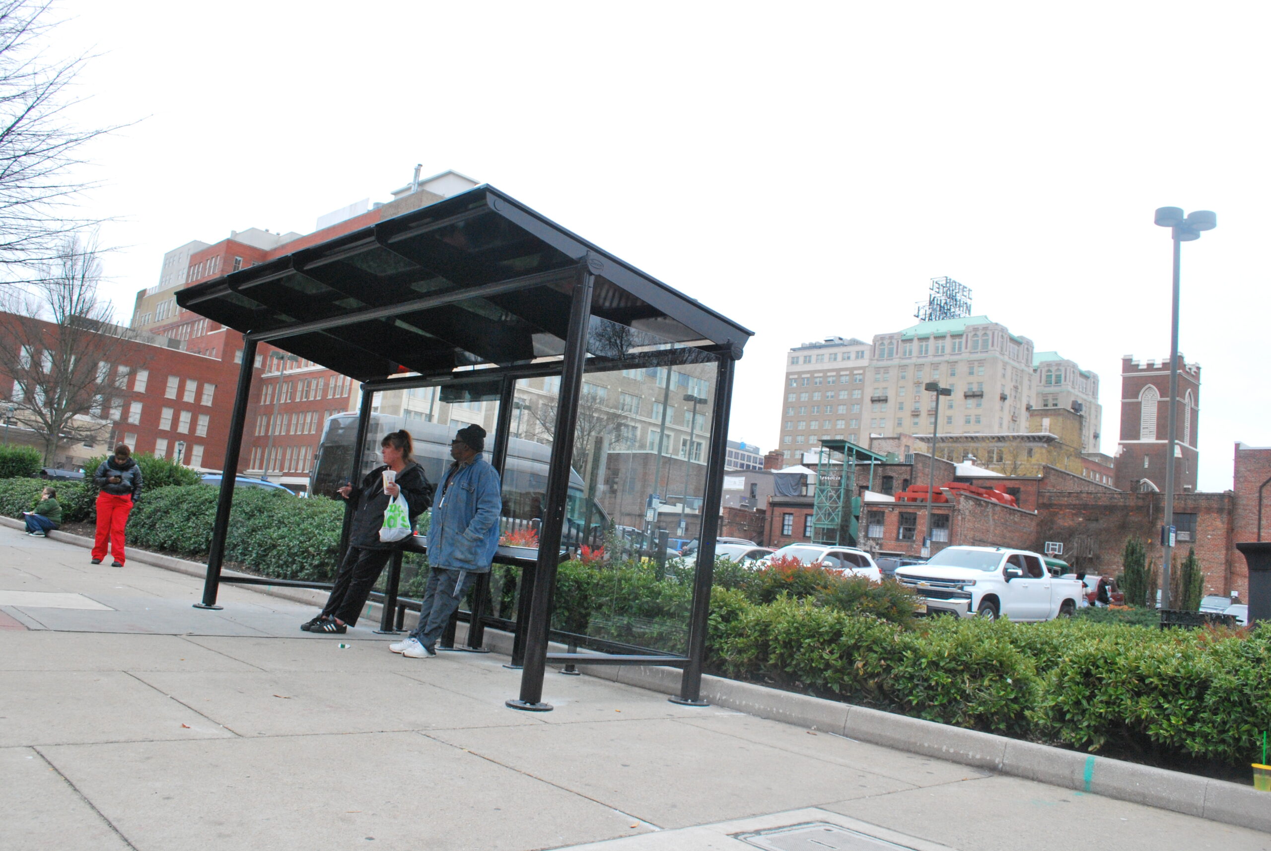 women waiting for bus in covered bus stop