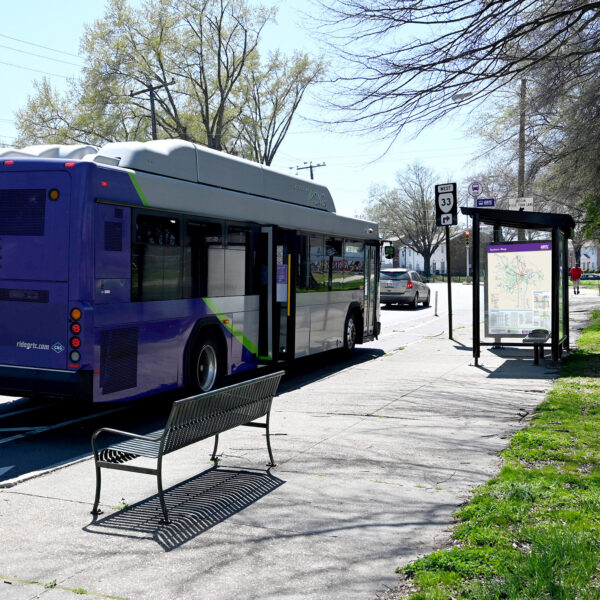 A bus pulled in next to a bus shelter