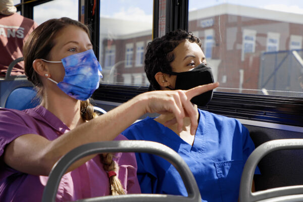 Nurses in masks riding the bus