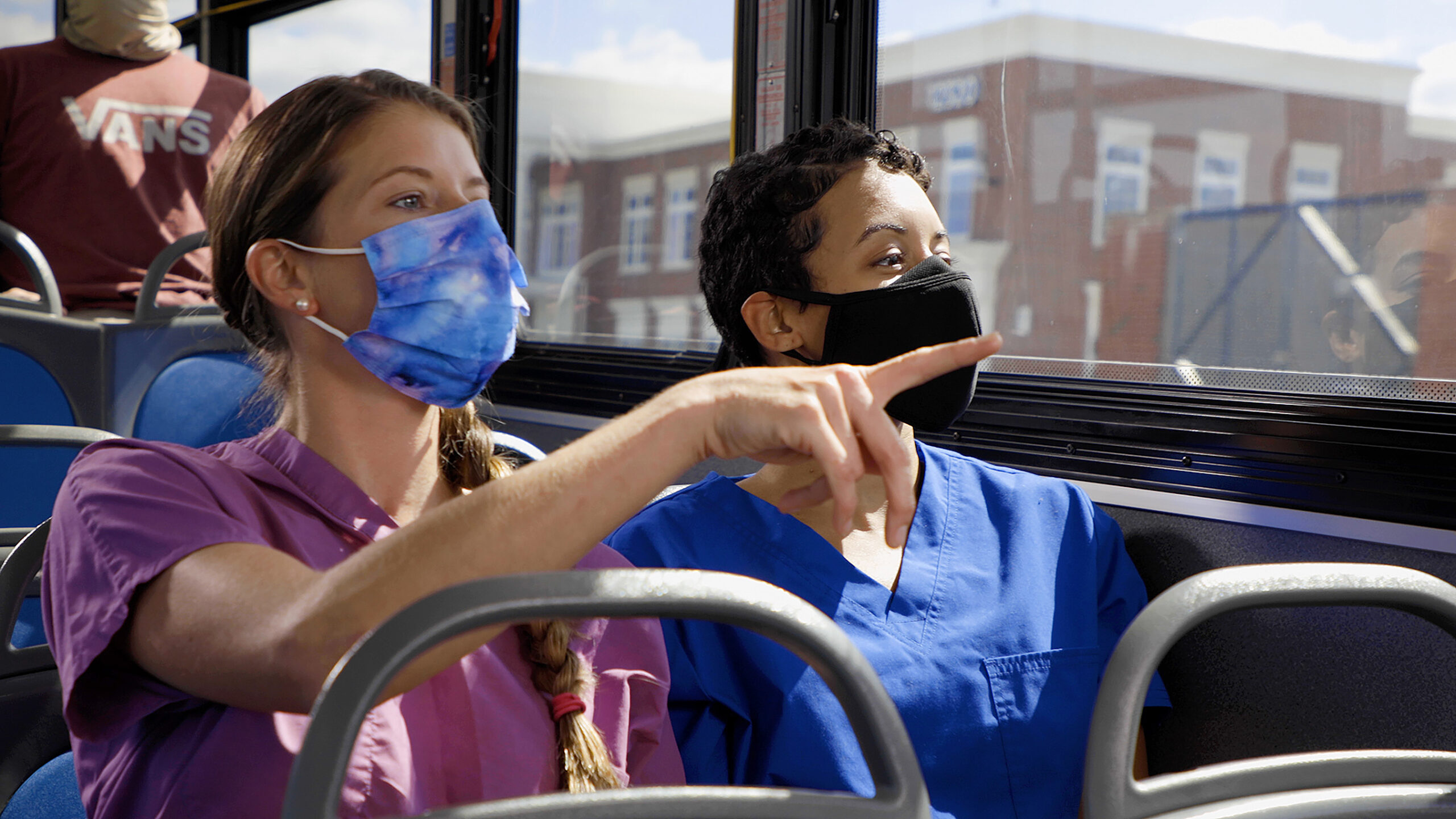 Nurses in masks riding the bus