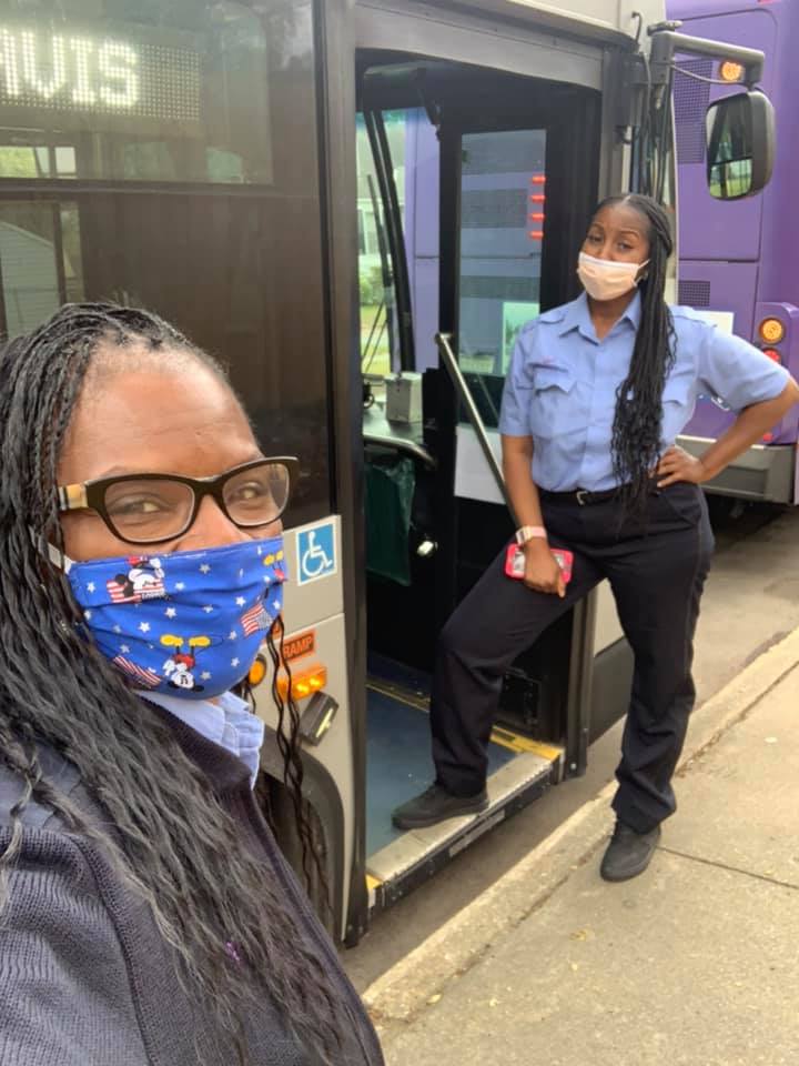 two bus operators wearing face masks