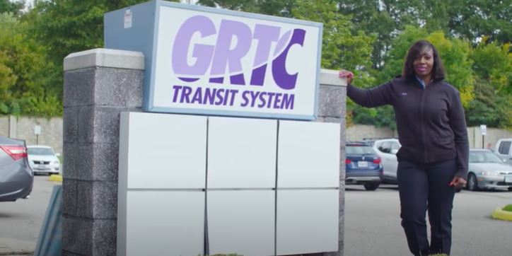 Operator Tabitha standing outside beside the GRTC sign