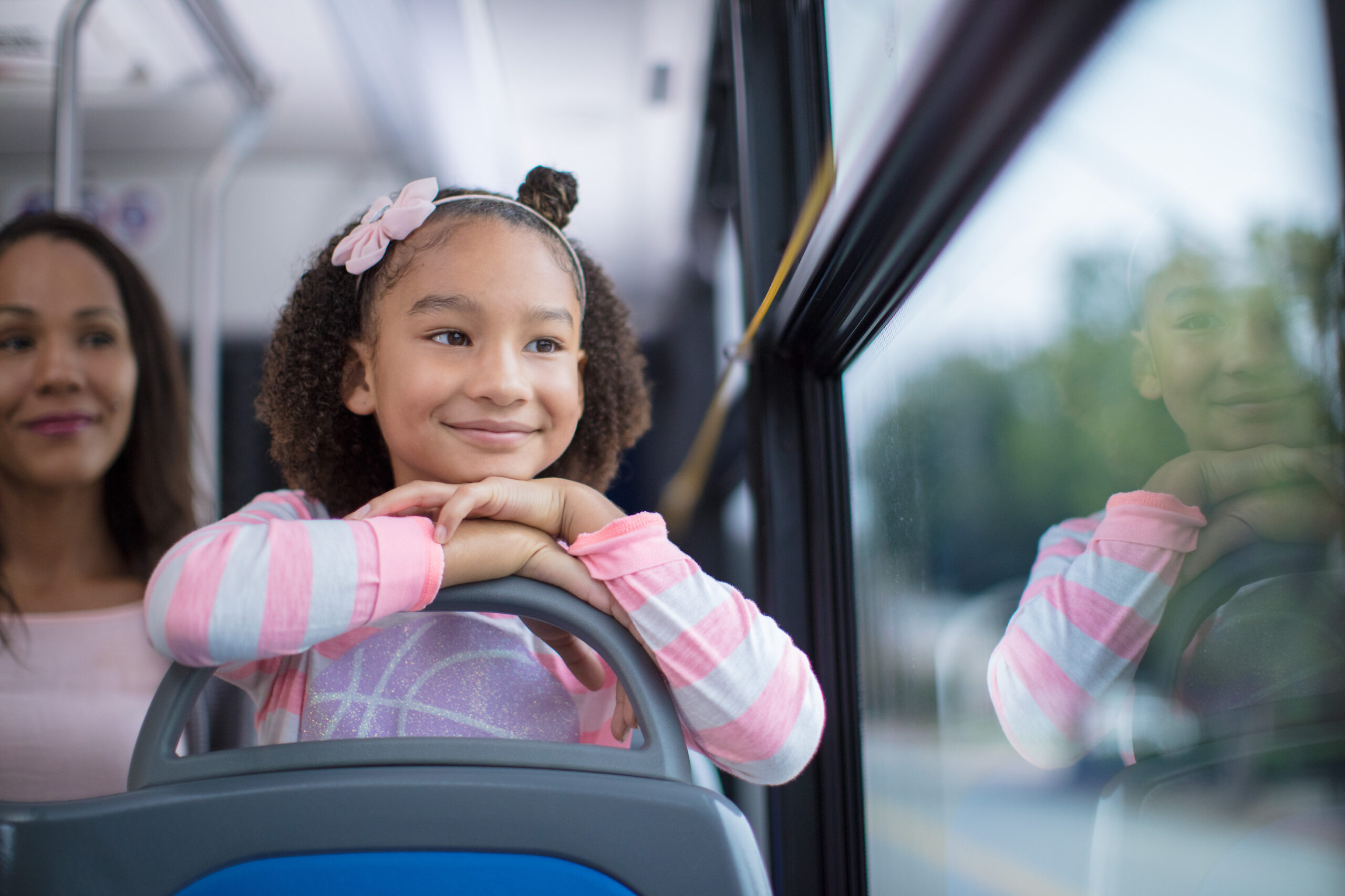 Girl riding a GRTC bus, looking ahead through the window