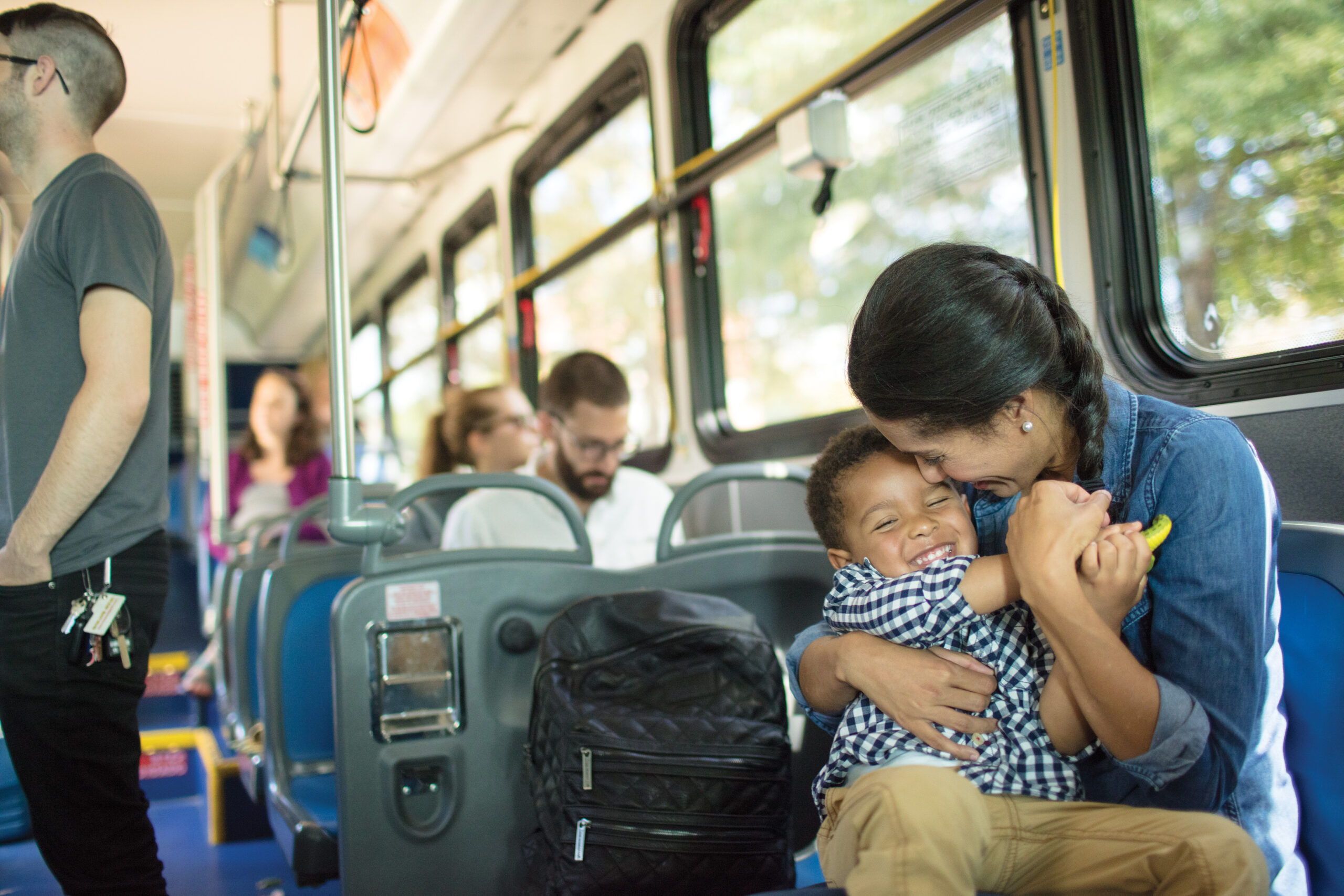 Mom and kid hug on the bus