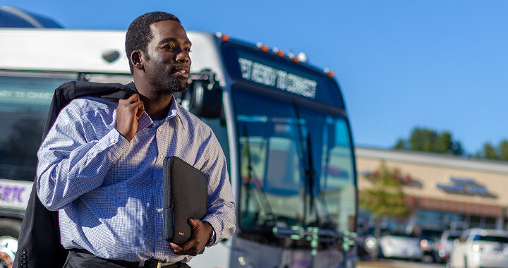 Commuter in front of bus