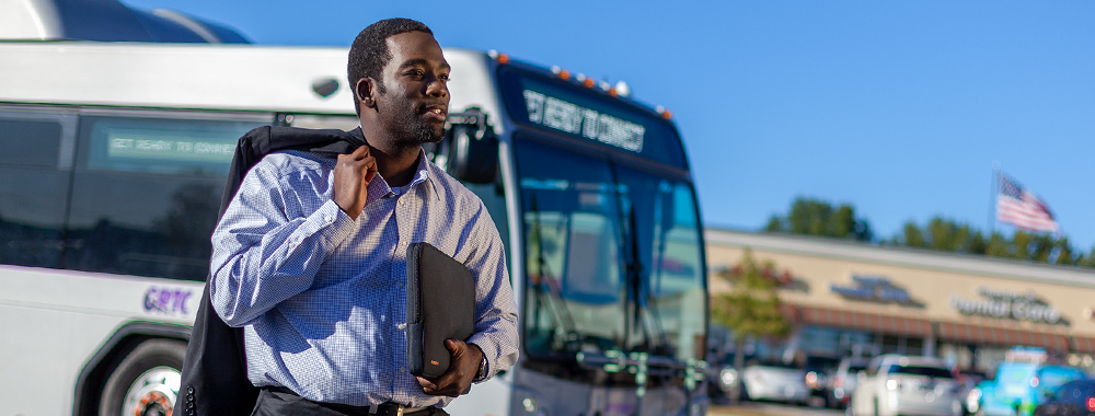 Commuter in front of bus