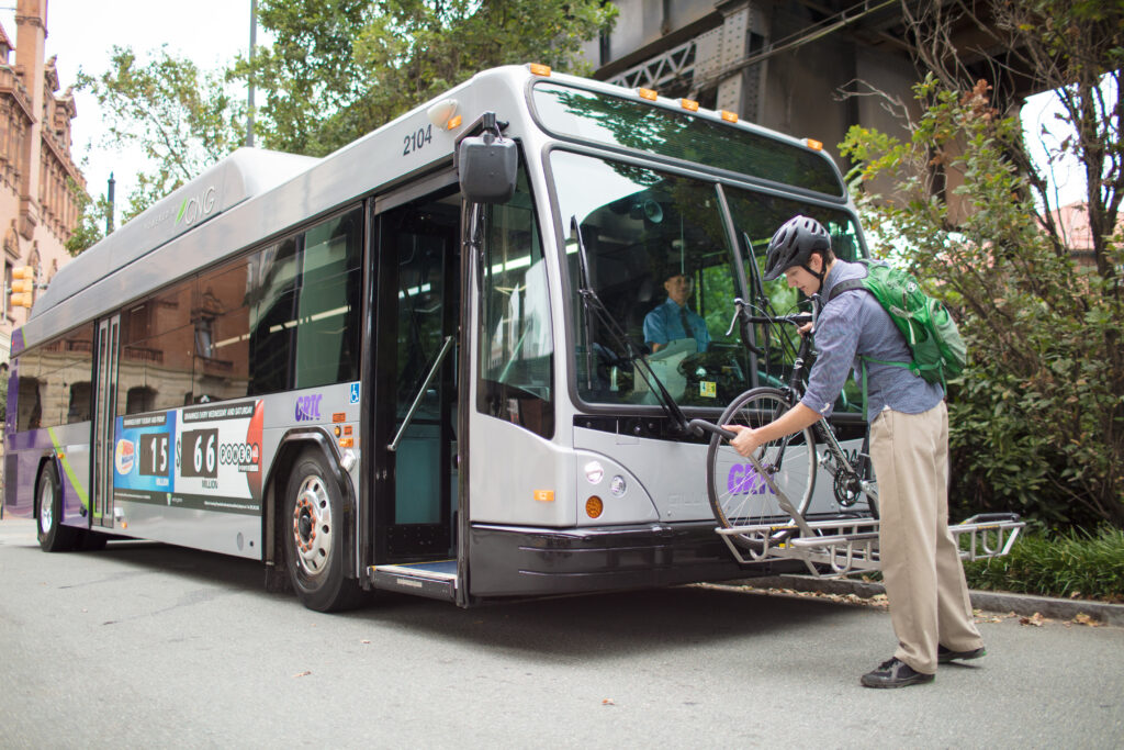 A rider secures his bicycle to the bike rack