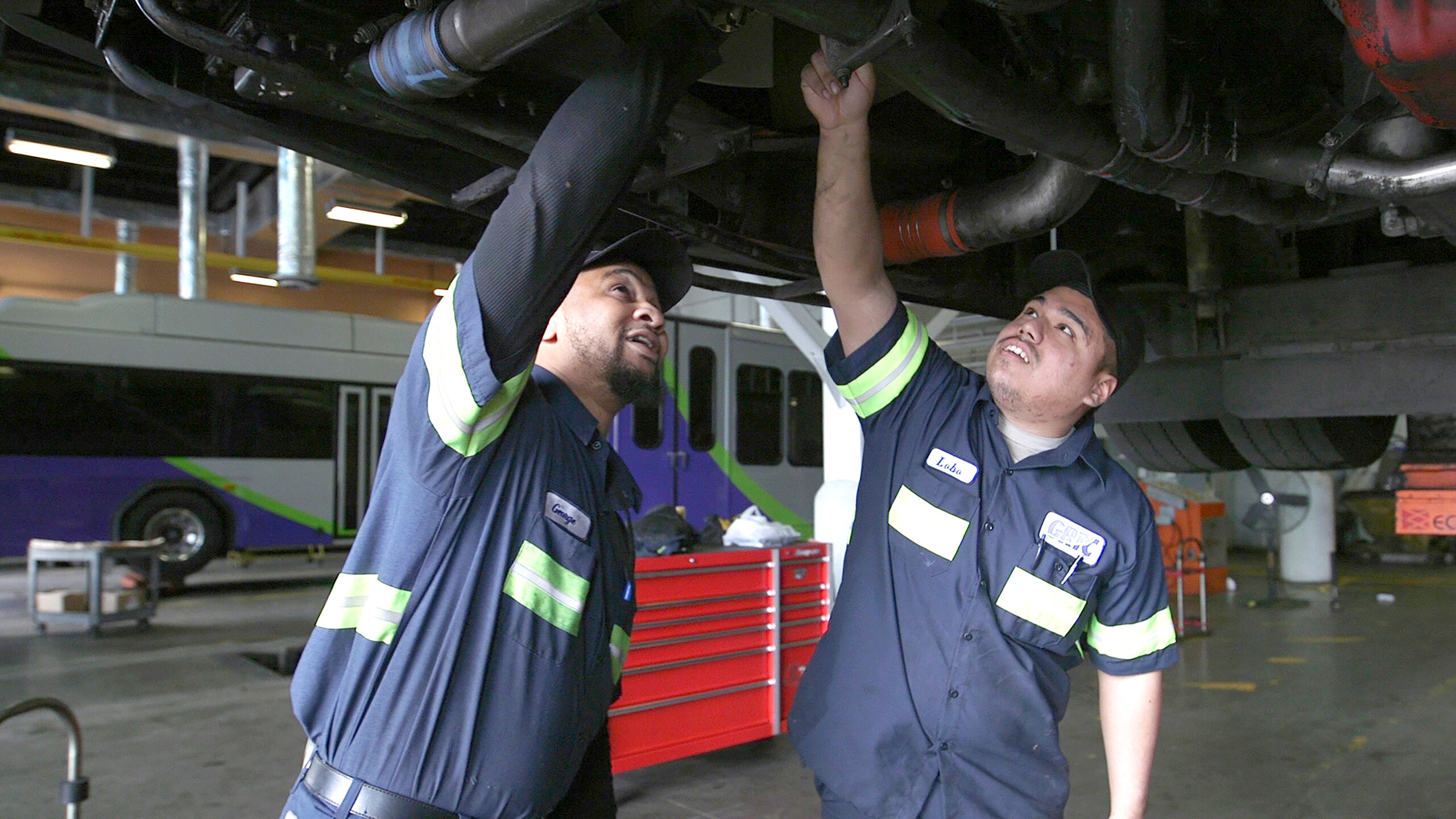 Maintenance team working on a vehicle in the shop