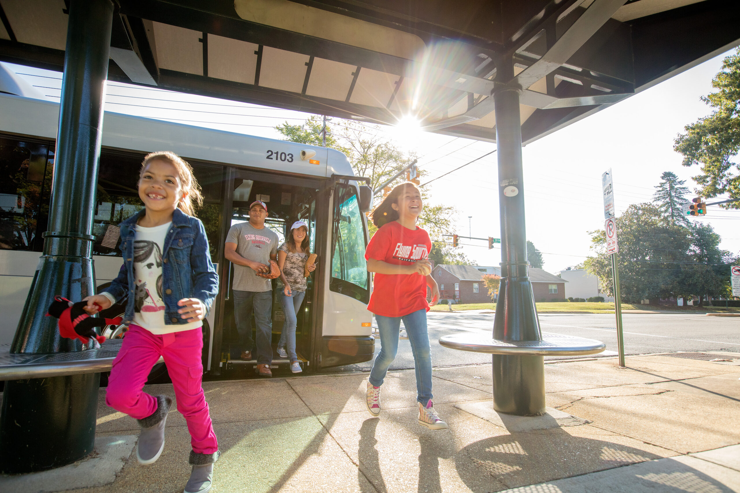 A family alights the bus at their destination to see the Flying Squirrels